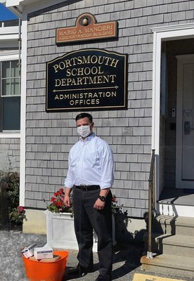 Dr. Thomas Kenworthy, superintendent of Portsmouth, RI schools, accepts facial mask donations from Embrace Home Loans