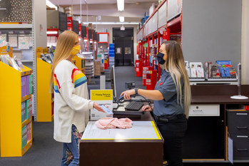 Staples employee scanning Happy Returns QR code to verify the return and initiate the refund.