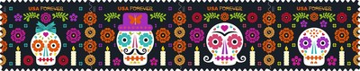 The four colorful Day of the Dead stamps feature several iconic elements of a traditional Day of the Dead ofrenda. Stylized, decorated “sugar skulls” are personalized as four family members, one per stamp: a child with a hair bow, a father sporting a hat and mustache, a mother with curled hair and another child.