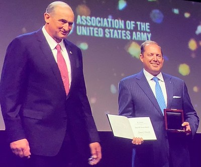 James Schenck holds the 2021 John W. Dixon Award from the Association of the United States Army.