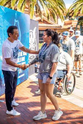 Veteran Vanessa Brown is greeted by WHOW Tournament Founder and loanDepot Founder and CEO Anthony Hsieh. The 2021 WHOW tournament is the first WHOW event that included two all-female combat-wounded teams.
