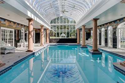 The estate’s indoor pool features a Machin Conservatory glass ceiling (made popular in the U.K.) that was custom-made by artisans in North Carolina. A large hot tub is adjacent to the pool, in addition to ample deck space. NewHampshireLuxuryAuction.com.