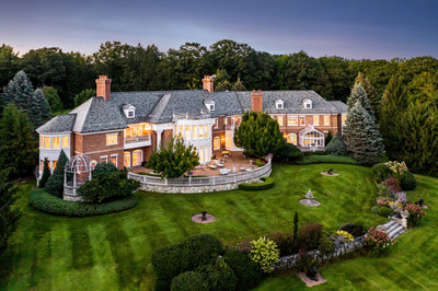 A sprawling patio overlooks the property’s neatly manicured lawns and serves as an excellent space for both quiet relaxation or celebrations on a grand scale. Mature landscaping around the estate augments its privacy. NewHampshireLuxuryAuction.com.