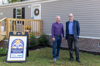 Kevin Clayton, Clayton CEO, and Claas Ehlers, Family Promise CEO, stand in front of the home Clayton donated to the nonprofit.