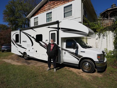 Home of the Free Promotion Winner, Tim Bell, stands in front of his new 2021 Jayco Redhawk