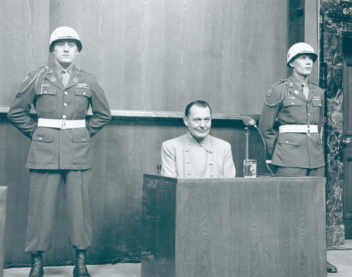 Surrounded by guards, Hermann Goering testifies during the Nuremberg trials. Possible interactions between a young, Jewish interpreter assigned to the trials and Goering is the basis of The Theater Project's thought-provoking live streaming of 'The Interpreter', November 4-14. --Photo courtesy of the Robert H. Jackson Center