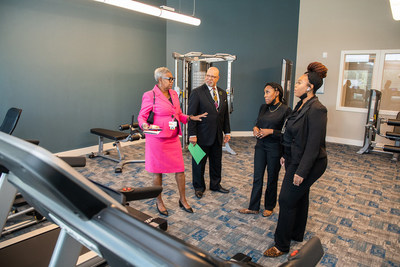 On the left, Janice Weaver, President & Founder, One Body Networking, Inc., and Keith Bynam, Interim Director, City of Houston Housing & Community Development Department, visit the fitness center during a tour of the AMTEX Green Oaks Apartments, a new 177-unit affordable housing community in northeast Houston.