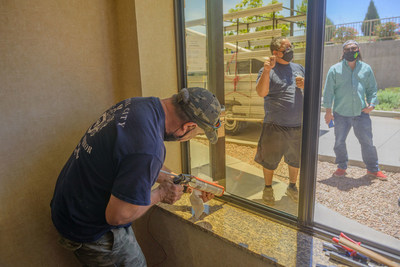Santa Fe-based glazer Capital City Glass installs a UbiQD solar window at the Holiday Inn Express and Suites in Los Alamos, New Mexico. Photo credit: UbiQD, Inc.