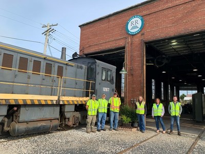 River Ridge Railroad team members (left to right) Troy McCoy, Rickie Newton and Ron Hammond join OmniTRAX colleagues Kelli Dunn, Christine Duke and Scott Remington to mark the first day of OmniTRAX rail service in River Ridge Commerce Center.