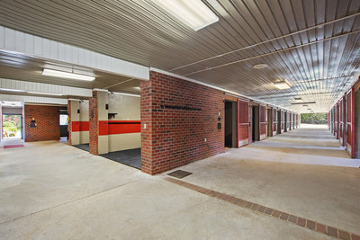 Essentially all the farm’s structures were built to a ‘commercial-grade’ standard, with concrete block and brick used extensively throughout. Stalls in the main barn’s lower level (shown here) feature brick-over-concrete walls and custom, sliding doors made of steel. NorthCarolinaLuxuryAuction.com.