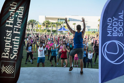 A dance workout instructor leads the crowd at a Wellness Wednesday event in Doral, Florida. The series is part of the ongoing partnership between Mind Body Social and Baptist Health, which started in 2019 and has just been extended and expanded to continue offering free community fitness & wellness events throughout South Florida until 2024
