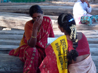 A woman in India after the 2004 tsunami receives a Scientology assist from a Volunteer Minister.