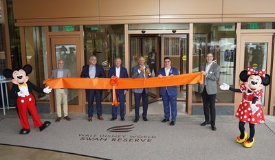 Pictured from left to right are: Mickey Mouse, Tishman Hotel and Realty Chairman and CEO John Vickers, MetLife Director of Hotel Asset Management Bill Webster, Marriott International President of US Eastern Region Jim Connelly, Principal Owner and Vice Chairman of Tishman Hotel and Realty Dan Tishman (with scissors), Walt Disney World Swan and Dolphin Resort Area General Manager Sean Verney, Walt Disney World President Jeff Vahle and Minnie Mouse