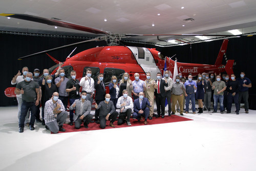 Canadian Coast Guard and Bell Textron Canada staff pose in front of the 16th Bell 429 helicopter delivered to the Coast Guard on September 15, 2021. (CNW Group/Canadian Coast Guard)