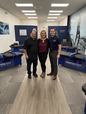 Stretch Zone Anchorage studio owners Ray & Suzanne Hickel, together with CEO Tony Zaccario, at the grand opening celebration.