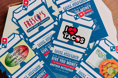 Select Domino's stores throughout Boston, Phoenix, Louisville, Denver, and Laredo, Texas, bought thousands of $50 gift cards from local restaurants and surprised randomly selected Domino's delivery customers with them in early November.