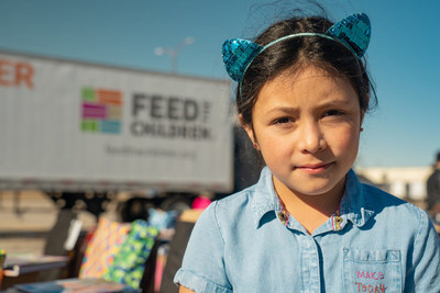 A child participates in a Feed the Children distribution event. The nonprofit is kicking off their No Hunger Holidays campaign, serving thousands of Oklahoma families and providing more than two million meals across the U.S. this holiday season.