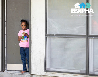 A young resident of an East Baton Rouge Parish Housing Authority community waits outside while her new bed was installed recently.
The agency is currently implementing a comprehensive strategic plan to provide residents with better ACCESS to education, health and wellness, and economic opportunities.