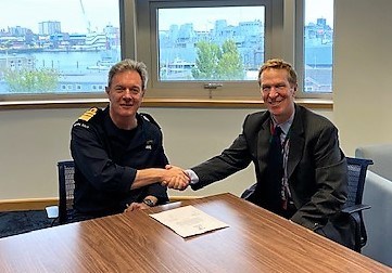 Photo shows Second Sea Lord, Vice Admiral Nick Hine, CB and Hayden Stafford, president of global client engagement, Pegasystems signing the Armed Forces Covenant.