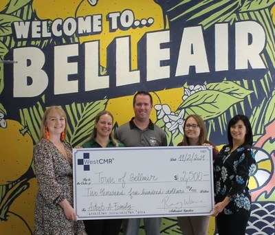 WestCMR team members deliver the check to the Town of Belleair.