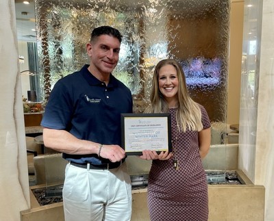 Ignacio Quinones, owner and president of North Star Senior Advisors, presents the 2021 Excellence Award to Brittney Fielden, Community Relations Director, honoring Watercrest Winter Park Assisted Living and Memory Care for outstanding service and quality.