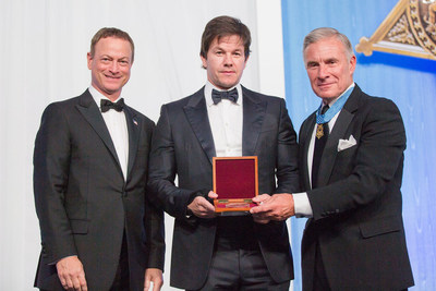 Actor and producer Mark Wahlberg (center) received the Bob Hope Award for Excellence in Entertainment for his support of American troops and his positive portrayal of the military at the 2014 Medal of Honor Celebration in Knoxville. He is flanked by actor and former Society award winner Gary Sinise (left) and Medal of Honor Recipient Paul Bucha (right).