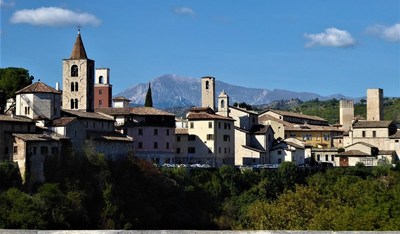 The Sibillini Mountains rise behind the towers of Ascoli Piceno