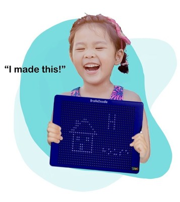 Blind girl holding the BrailleDoodle saying, "I made this!"