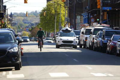 An Argo AI self-driving test vehicle shares the road with a cyclist in Pittsburgh.