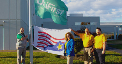 Jennifer Ralph, Engineering Technician; Robert Valentine, Industrial Engineer; and Paul “Wayne” Stewart, First-shift Emblems Embroidery Team Lead, raises the Voluntary Protection Program (VPP) flag, given by Kentucky OSHA, to proudly display their newly acquired VPP certification status.