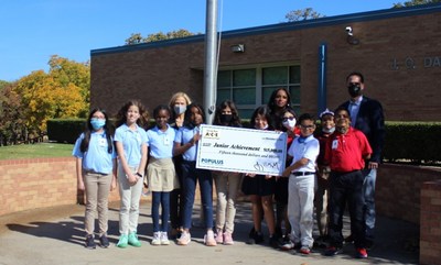 Populus Financial Group presents a $15,000 donation to Jan Murfield, President at Junior Achievement of Dallas at J.O. Davis Elementary School