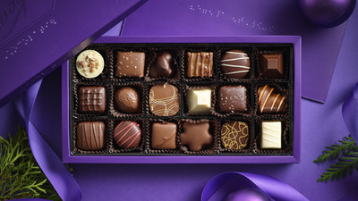 A box of Purdys chocolates with braille on the lid, open on a purple background. (CNW Group/Purdys Chocolatier)