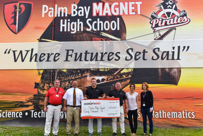 Ken Gregg (CEO/Founder) and Ryan Jesenik (SVP) of Orion180, deliver a $20,000 check to local Melbourne, Florida high school, Palm Bay High.