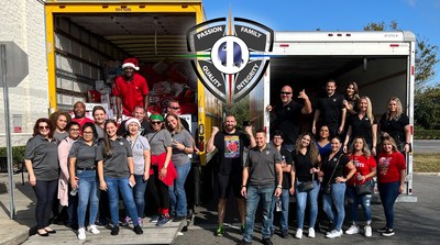 The employees of Quality One Wireless with WWE star Mojo Rawley, filling up two 26' box trucks worth of toys, bikes and goods for disadvantaged families in the Central Florida area.