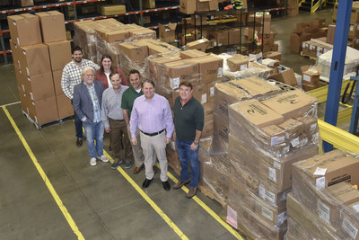 Mike Tutor, Radians CEO, and Bill England, President, stand with the Radians New Product Development Team by PPE pallets donated to Matthew 25: Ministries to help with the December tornado outbreak.