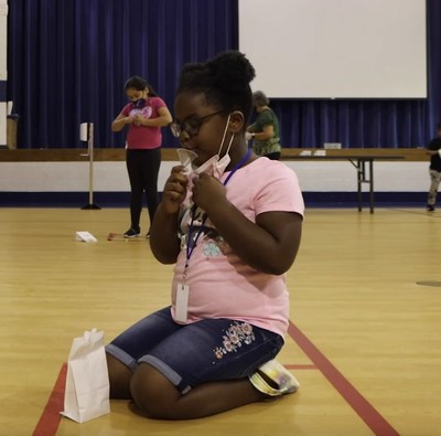 A student at Hillside District 93 in Hillside, Illinois, provides a saliva sample for SHIELD Illinois' COVID-19 test.