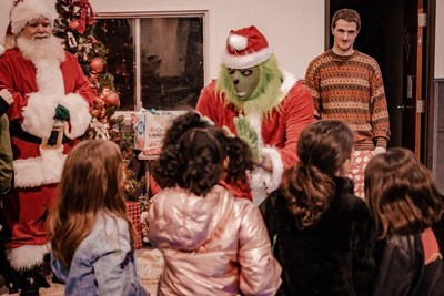 The Grinch was the center of the party, challenging Santa and pretending to take presents from the children, as the corporate elves saved the day.