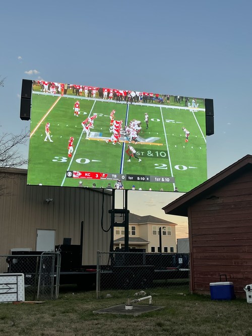 23' x 13' Xtreme Mobile LED Screen towering over a client's house for a Super Bowl party in Austin, TX