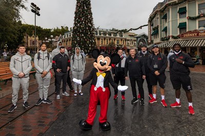 The Ohio State University Buckeyes and Utah Utes Welcomed at Disneyland Resort Before Rose Bowl Game on New Year’s Day: The head football coaches and select players from the teams pose for a photo with Mickey Mouse at Disneyland Park, in Anaheim, Calif., Dec. 27, 2021. The teams made their first stop on the way to the 2022 Rose Bowl Game presented by Capital One Venture X in Pasadena, Calif., with a visit to the Disneyland Resort. (Christian Thompson/Disneyland Resort)
