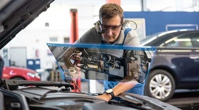 Worker using Vuzix Smart Glasses and TeamViewer software for auto repair