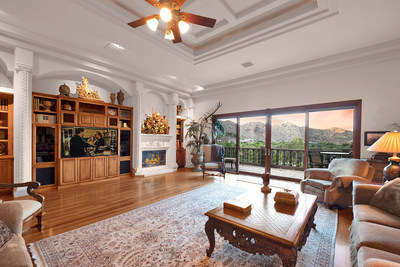 Large common areas and volume ceilings define the interiors. Pictured here: the grand salon, with one of the home’s several working fireplaces. The salon served as a central gathering area for many events and parties the owners held at the home over the years. Visit ParadiseLuxuryAuction.com.