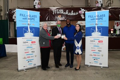 (From L to R) Pennsylvania Dairy Farmer Dina Zug, PA Secretary of Agriculture Russell Redding, Former NFL Player and Super Bowl Champion Torrey Smith and Pennsylvania Dairy Princess Mikayla Davis raise a toast to kick of Fill a Glass with Hope.