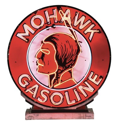 Rare and exceptional Mohawk Gasoline circular porcelain neon service station sign with Native American graphic and original cast-metal mounting stand. Produced in the 1930s for Mohawk Oil Co., Bakersfield, California. 9.0+ condition. Sold at Morphy's Oct. 3-4, 2021 Automobilia & Petroliana Auction for its high-estimate price of $120,000