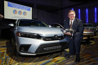 The 2022 Honda Civic was named 2022 North American Car of the Year this morning in Detroit. Honda North Central Zone Manager Matt Almond displays the trophy for the award at the press conference today.