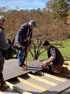 Kevin O'Connor, This Old House host, secures boards and clips with the CAMO LEVER board bending and locking tool, while Tom Silva prepares to fasten with the new ClipDRIVE stand-up tool.