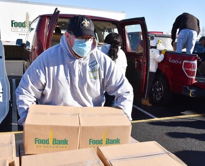 Kris Risks, a Perdue associate in Delaware, helps load boxes of food as part of a holiday distribution in partnership with the Food Bank of Delaware. In 2021, Perdue Farms donated more than 5.3 million pounds of protein to support hunger relief.