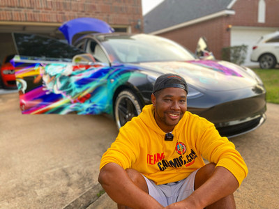 Carmic.Con Owner Koriey Dixon breaks from preparing his Itasha Tesla Model 3 for a quick fan photo.