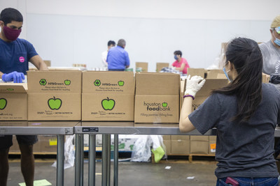 Volunteers packing boxes at the Houston Food Bank