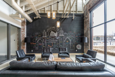 The wall of windows in the lobby at The Mill was once an overhead door, where lumber was brought in to be cut down to size to make furniture for the Showers Brothers Furniture Company.