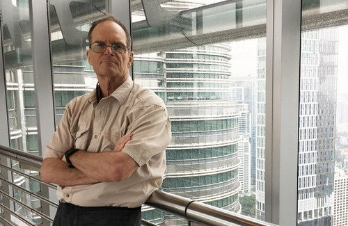 Tal Newhart owner of SuperHub.com and author of The Art of Corporate Warfare. Here pictured in Petronas Towers, Kuala Lumpur.